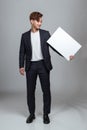 Studio portrait of an East Asian man holding a white board
