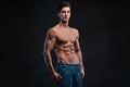 Shirtless muscular male over dark background. Royalty Free Stock Photo