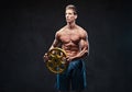 Ectomorph shirtless athletic male holds barbell weight.