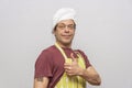 Studio portrait of an elderly man 45-50 years old with a tattooed QR code on his shoulder, a chef`s hat and an apron.  Concept: hi Royalty Free Stock Photo