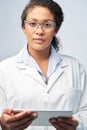 Studio Portrait Of Female Laboratory Technician Working With Digital Tablet