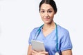 Studio Portrait Of Female Nurse Wearing Scrubs Holding Digital Tablet Royalty Free Stock Photo