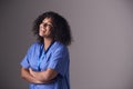 Studio Portrait Of Female Nurse Wearing Scrubs Standing Against Grey Background Royalty Free Stock Photo