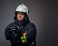 Studio portrait of firefighter dressed in uniform.