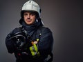 Studio portrait of firefighter dressed in uniform.