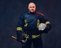 Firefighter holds the axe. Royalty Free Stock Photo