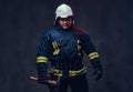 Firefighter holds the axe. Royalty Free Stock Photo