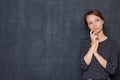 Portrait of focused pensive young woman touching face with hand Royalty Free Stock Photo