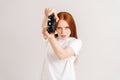 Studio portrait of focused young woman playing video game with controller looking at camera on white isolated background Royalty Free Stock Photo