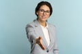 Friendly hospitable cheerful business woman or office worker wear blazer giving hand to handshake Royalty Free Stock Photo