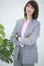 Close up portrait of a serious business woman in gray suit standing in the city Royalty Free Stock Photo