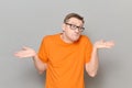 Portrait of funny confused man raising and spreading hands Royalty Free Stock Photo