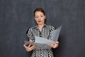 Portrait of funny shocked office girl looking at papers