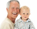 Studio Portrait Of Grandfather Holding Grandson Royalty Free Stock Photo