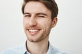 Studio portrait of handsome european male boyfriend making pass on hot woman sitting alone in bar, winking and smiling Royalty Free Stock Photo