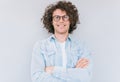 Studio portrait of handsome smart-looking smiling male posing for advertisement wears denim shirt and round glasses, isolated on Royalty Free Stock Photo