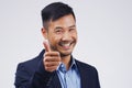 Great job. Studio portrait of a handsome young businessman giving a thumbs up against a grey background. Royalty Free Stock Photo