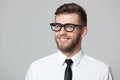 Studio portrait of handsome young businessman smiling and winking. Royalty Free Stock Photo