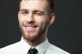 Studio portrait of handsome young businessman smiling and winking. Royalty Free Stock Photo