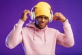 African man in hoodie with headphones isolated, happy expression. Music, people Royalty Free Stock Photo