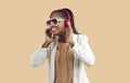 Studio portrait of happy black woman in headphones listening to her favorite playlist Royalty Free Stock Photo