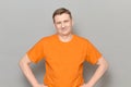 Portrait of happy blond mature man wearing orange T-shirt Royalty Free Stock Photo