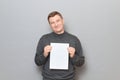 Portrait of happy man holding white blank paper sheet in hands Royalty Free Stock Photo