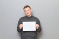 Portrait of happy man holding white blank paper sheet in hands Royalty Free Stock Photo