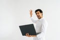 Studio portrait of happy excited cheerful young man in shirt posing with laptop computer and looking to screen device Royalty Free Stock Photo