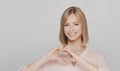 Studio portrait of happy and expressive young blond woman.