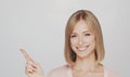 Studio portrait of happy and expressive young blond woman.