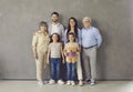 Studio portrait of happy multi generational family standing together and smiling