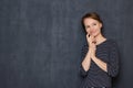 Portrait of happy thoughtful girl touching face with hand and smiling Royalty Free Stock Photo