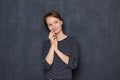 Portrait of happy thoughtful girl touching face with hand and smiling Royalty Free Stock Photo