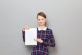 Portrait of happy young woman holding white blank paper sheet Royalty Free Stock Photo