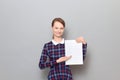 Portrait of happy young woman holding white blank paper sheet Royalty Free Stock Photo