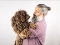 Studio portrait of a hipster man hugging his dog. Man playing with dog Isolated on white background Royalty Free Stock Photo