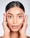 Studio portrait of Indian woman with hands for skincare, beauty and cosmetics on white background. Dermatology, spa and Royalty Free Stock Photo