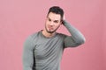 Studio portrait on an isolated background of a young athletic man smiling and scratching his head pondering over the proposal Royalty Free Stock Photo