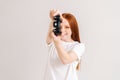 Studio portrait of joyful pretty young woman playing video game with controller looking at camera on white isolated Royalty Free Stock Photo