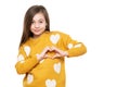 Studio portrait of a little girl on white background making a heart gesture with her hands. Fostering a child.