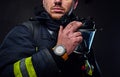 Studio portrait of a male dressed in a firefighter uniform.