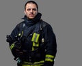 Studio portrait of a male dressed in a firefighter uniform.