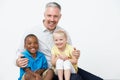 Studio Portrait Of Male Pre School Teacher With Pupils Royalty Free Stock Photo