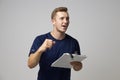 Studio Portrait Of Male Sports Coach With Clipboard