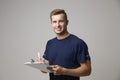 Studio Portrait Of Male Sports Coach With Clipboard