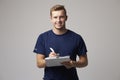 Studio Portrait Of Male Sports Coach With Clipboard