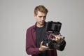 Studio Portrait Of Male Videographer With Film Camera