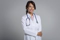 Studio portrait of middle aged female doctor against  background Royalty Free Stock Photo