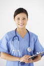 Studio Portrait Of Nurse Against White Background